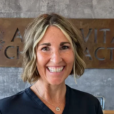 A headshot of a woman with short dirty blond hair smiling